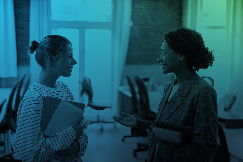 Two colleagues talking in an office